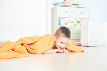 Portrait of a cute baby in orange plaid in home