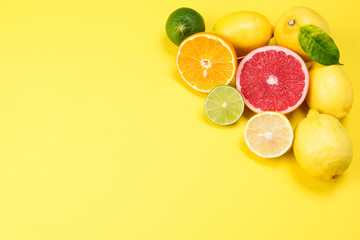 juicy citrus fruits in the corner of a yellow background