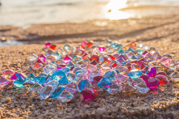 a lot of diamonds are scattered about on the beach.