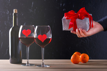 Male hands with red bow gift box. Valentine day.