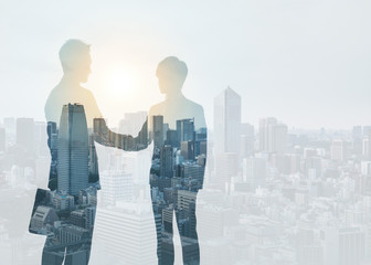 Marketing communication concept. Silhouette of business persons shaking hands.