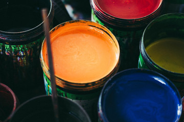 colorful paint cans on the clear wooden