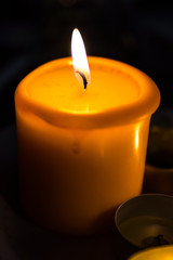 Burning candle in the dark