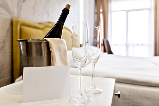 Honeymoon Concept. Champagne Bucket Near Bed In A Hotel Room