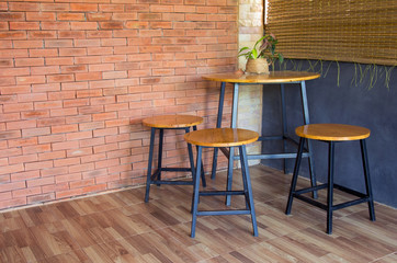 wood chair and table on brick wall