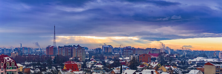 rays of the sun make their way through dramatic clouds over the city of Ivano-Frankivsk, Ukraine