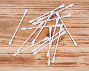 Organic double end cotton ear and make up swabs, buds on wooden vintage background