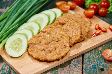 Vietnam fried fish patty with vegetable and sauce.