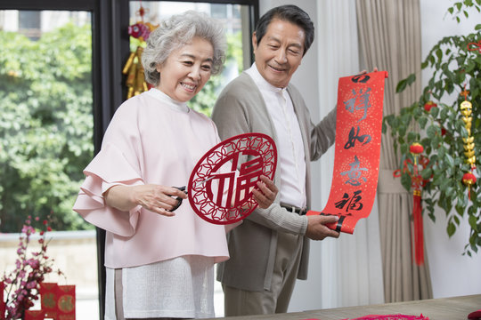 Cheerful senior couple celebrating Chinese New Year