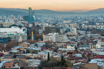 Fototapeta na wymiar TBILISI, GEORGIA - DEC. 12, 2017 : The city of Tbilisi in the evening taken from the hill