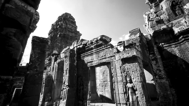 Boom up from ground featuring a bas relief sculpture of an apsara dancer on the exterior wall of Banteay Kdei.