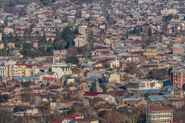 Fototapeta na wymiar TBILISI, GEORGIA - DEC. 10, 2017 : Tbilisi old town in the afternoon taken from the hill