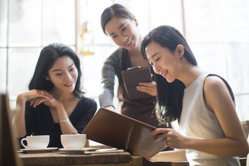 Best female friends drinking coffee in cafe_