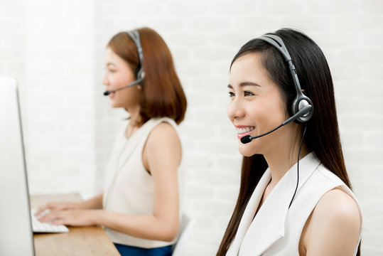 Asian woman telemarketing customer service agent team working in  call center