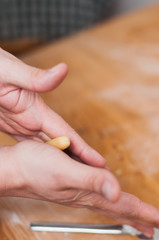 Obraz na płótnie Canvas Man's hands rolling sugar butter cookie dough to make traditional German Christmas butter cookies called Engelsaugen or Husarenkrapfen