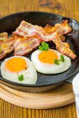 American breakfast with sunny side up eggs, bacon