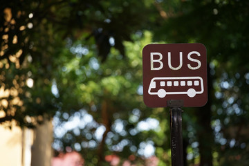 Scene of the signboard of the bus stop among the green which it was fine