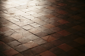 Old with cracked stone tiles on the floor of the old building