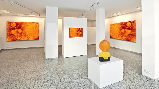 Cinemagraph- exhibition gallery, wall mounted art with museum style lighting, the abstract art is in movement 