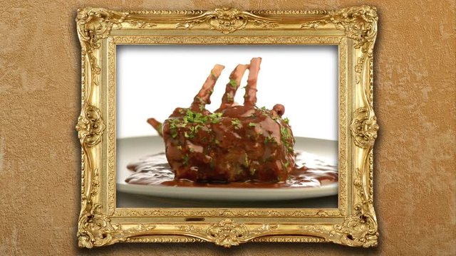 Cinemagraph- exhibition golden frame with close-up of juice roasted lamb chops in 360 degrees movement 