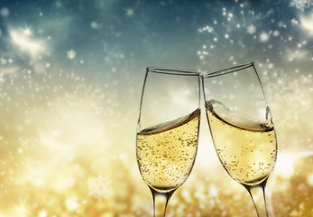 toasting with champagne glasses against holiday lights and new year fireworks