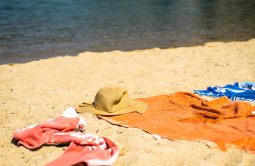 Sun hat and towels left on the beach