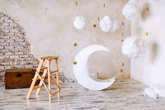 Children's location for a photo shoot. Moon with stars and clouds dreamy decor. Elements of the interior.
