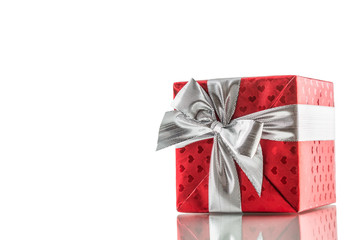 Christmas valentine or birthday red gift box with silver ribbon isolated on white