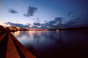 Havana bridge in Kiev at night with colorful illumination, beautiful clouds and reflection in Dnieper river. Wide angle