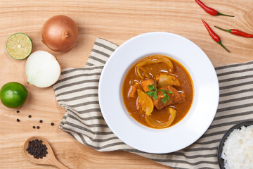 spicy chicken and rice on wooden background