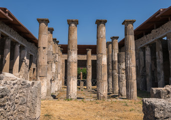 Walking around the ruins and the empty streets of the ancient antique site of Pompeii destroyed by...