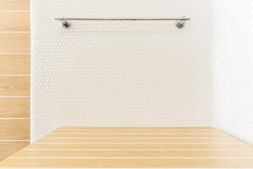 wood table with mosaic tile and hanger in bathroom