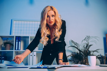 angry businesswoman pointing on documents on table