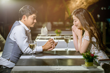 Man open a ring box to give a gift to his girlfriend.