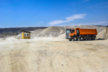 Gravel excavation site in a sunny day industrial machines.