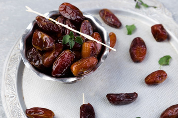 Dry fruit dates on silver tray. Copy space. Top view.