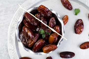 Dry fruit dates on silver tray. Copy space. Top view.