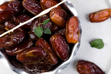 Dry fruit dates on silver tray. Copy space. Top view.