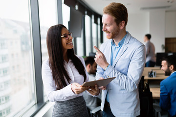 Obraz premium Attractive business couple using tablet in their company