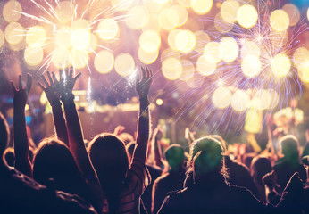cheering crowd watching fireworks - new year concept