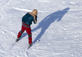 Fototapeta na wymiar Man skiing in the snow in winter