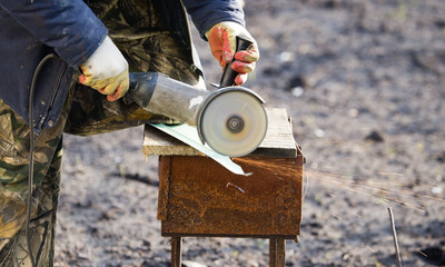 Working cut the metal sheet of the siding