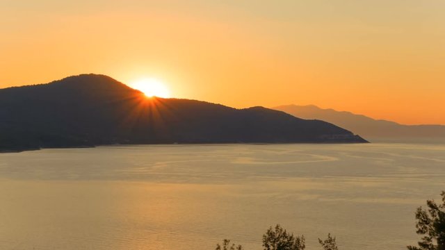 Inspirational panning sunset shot of the old port of Limenas, the Greek island of Thassos, Greece in the North Aegean Sea. Thasos is the northernmost Greek island, and 12th largest one.