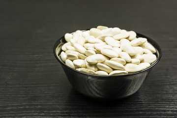Bowl with peas on the table.