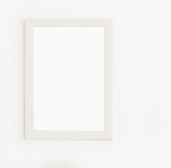 Obraz premium Light wooden frame for picture hanging on white wall. Blank picture. Template for design
