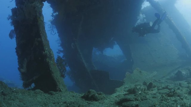 Diver swim through Tulamben wreck