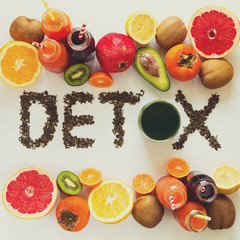 Healthy eating concept. Word 'detox' from green tea with colorful smoothies and fruits. Top view