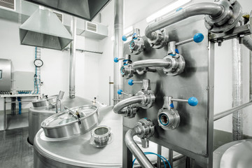 Equipment for the brewery. Large shiny tanks.