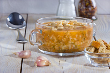  Soup with rice on the plate on wooden table.