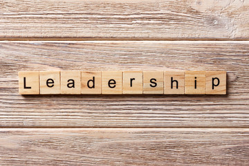 LEADERSHIP word written on wood block. LEADERSHIP text on table, concept